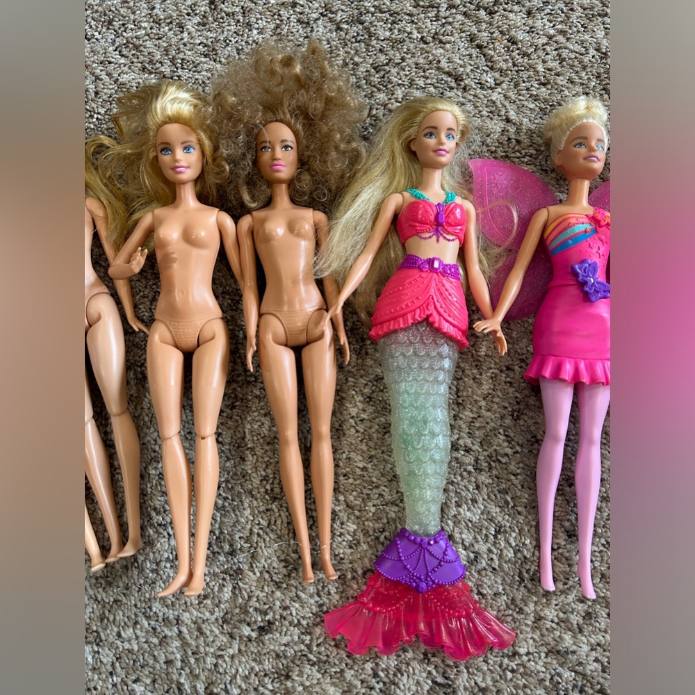 Lot of 8 Barbie Dolls.